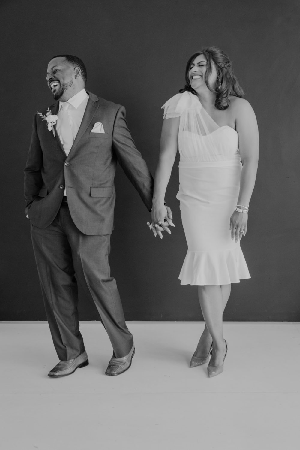 Ericka and Alex Gibson laughing together while holding hands